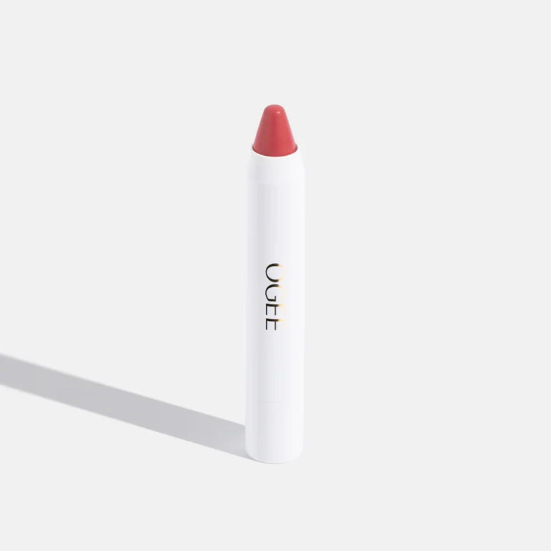 One stick of Ogee brand lip oil on white background